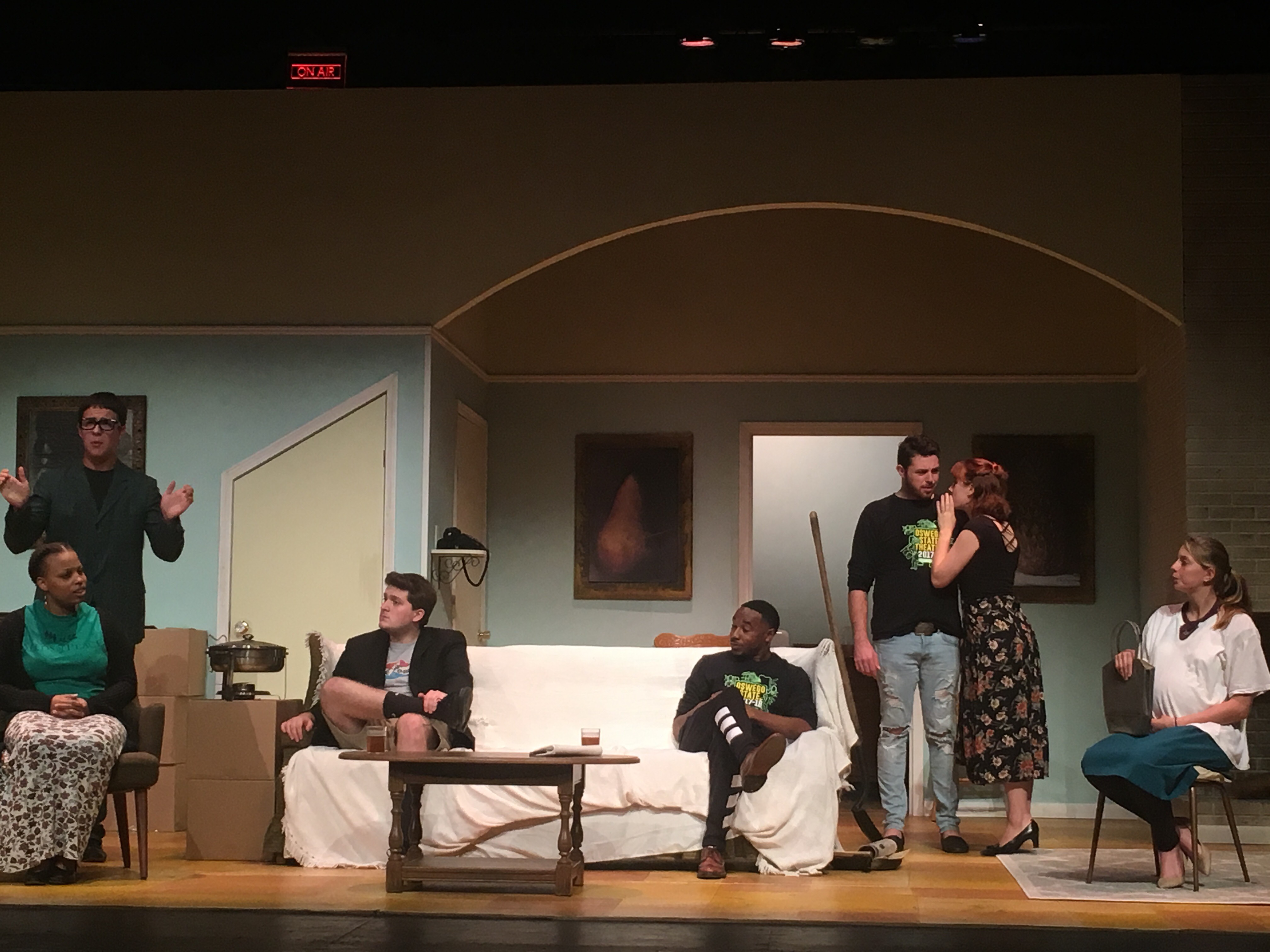 Rehearsal scene for Clybourne Park as actors stand and sit while having a discussion