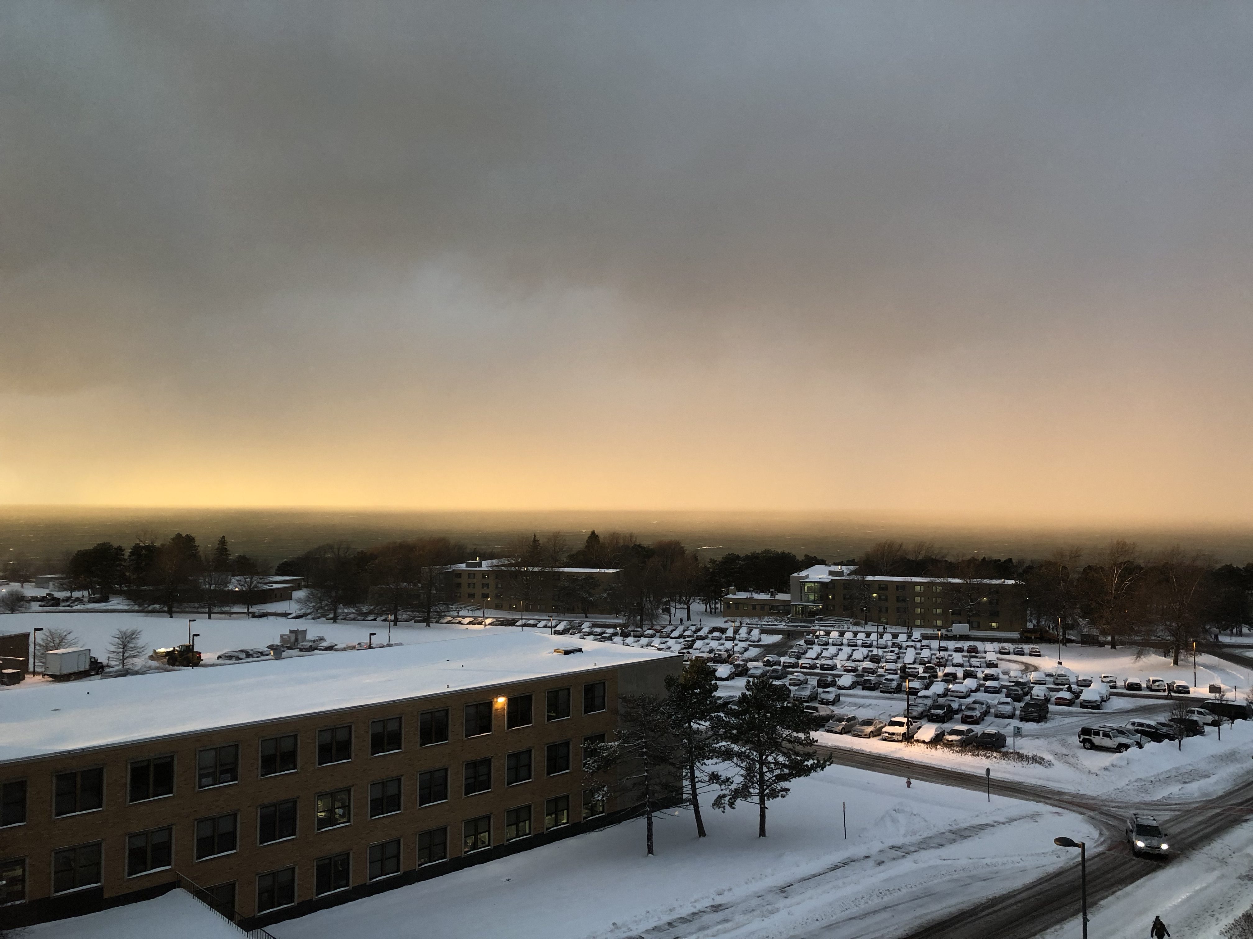 Foggy snowy sunset over Lake Ontario seen from roof of Shineman