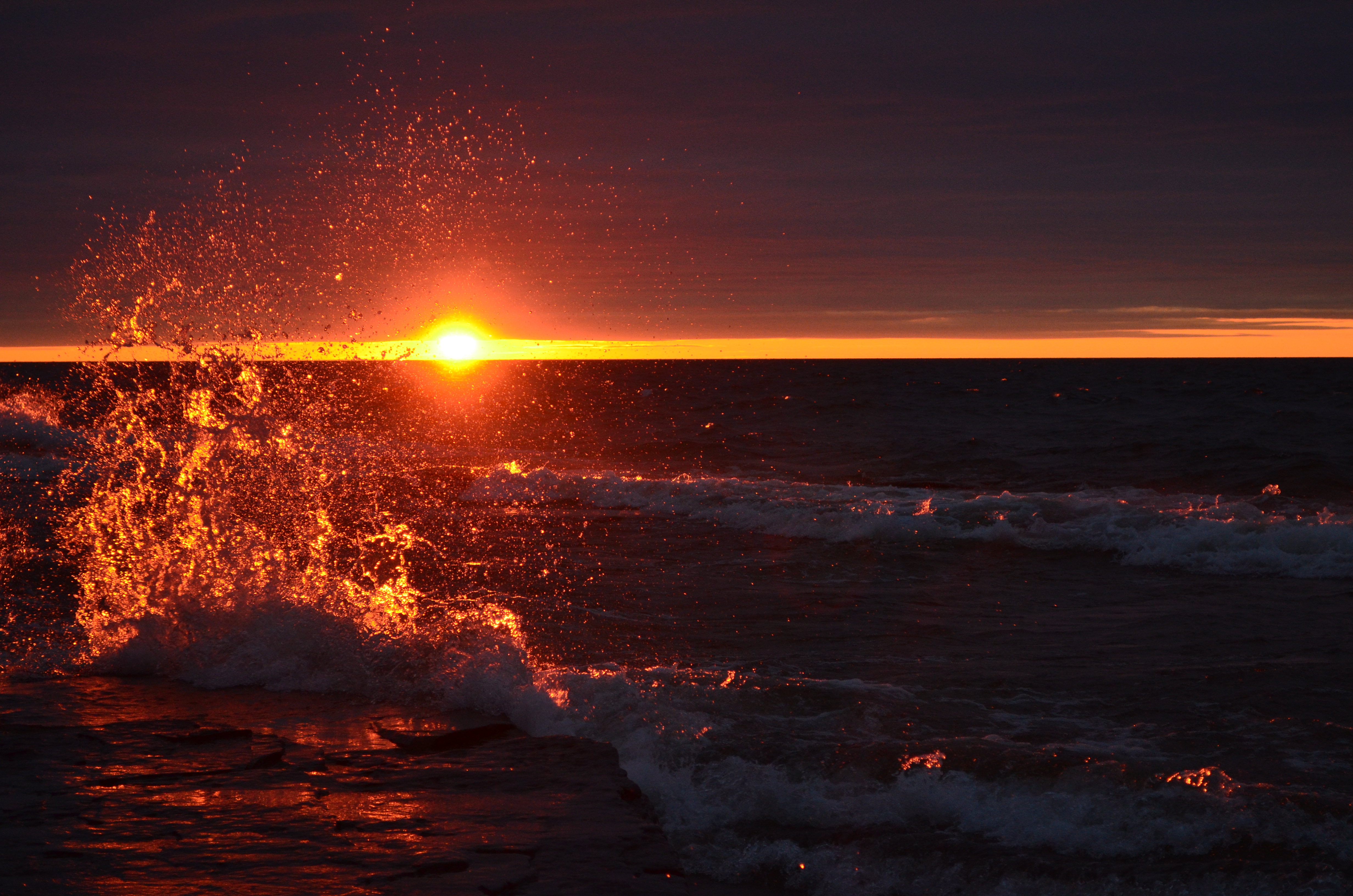 Red sunset over Lake Ontario as waves meet shore